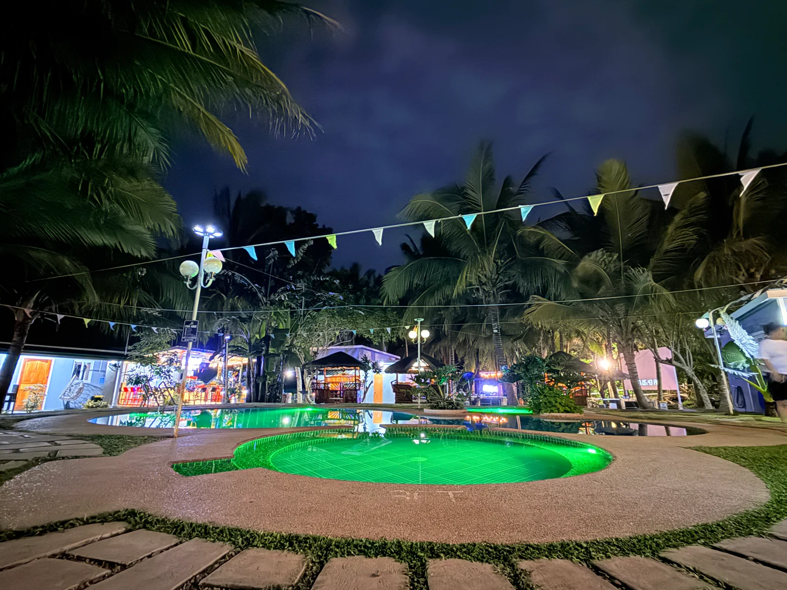 Illuminated swimming pools at Starksway Resort at night